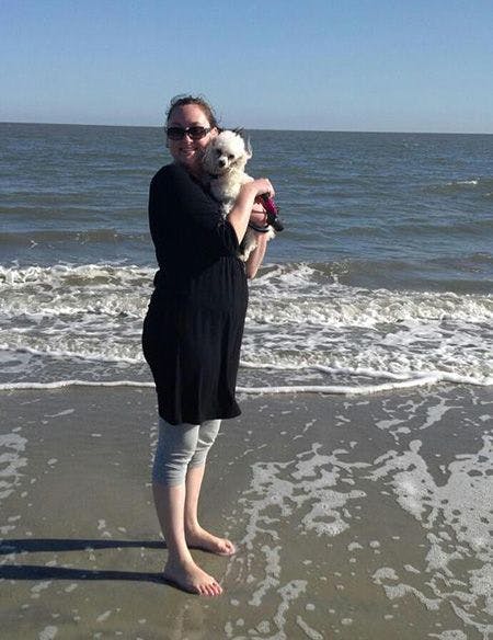 Parris on beach with her dog 