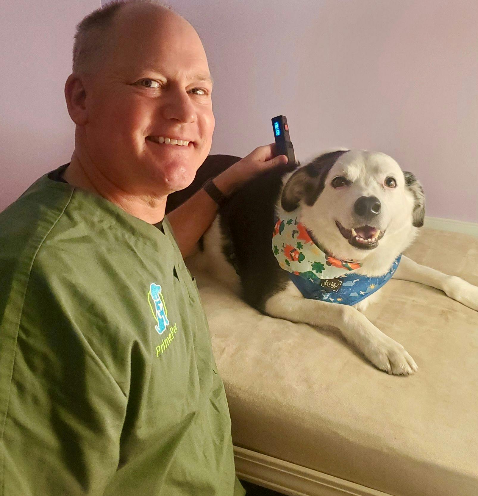 Tom Walsh, DVM, CCRP, MBA, owner of PrimePet Rehabilitation Therapy in Myrtle Beach, South Carolina, performing laser therapy on a patient.